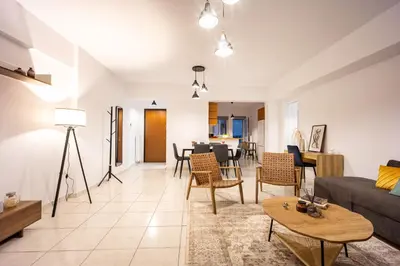 a living room with a couch and a table at Acropolis Retreat Stay in Style in Athens