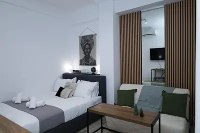 a bedroom with a bed and a table and a couch at steps to Lycabettus in Athens