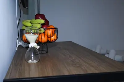 a basket of fruit sitting on a table with a vase at steps to Lycabettus in Athens