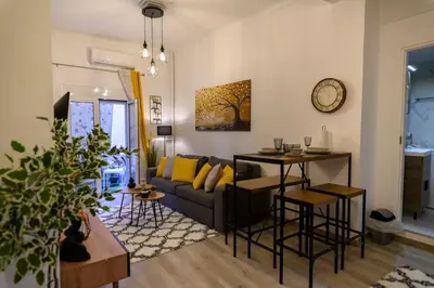 a living room with a couch and a table at Panathenaic Stadium 1bed Luxury in Athens