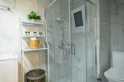 a shower stall with a glass door in a bathroom at Panathenaic Stadium 1bed Luxury in Athens