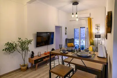 a living room with a table and a tv at Panathenaic Stadium 1bed Luxury in Athens