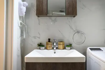 a bathroom with a white sink and a phone at Panathenaic Stadium 1bed Luxury in Athens