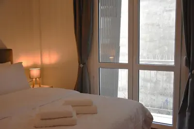 a bedroom with a bed and a large window at Athens Quite Flat, Vibrant neighborhood & Large Balcony in Athens