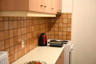 a kitchen with a stove top oven next to a counter at Athens Quite Flat, Vibrant neighborhood & Large Balcony in Athens