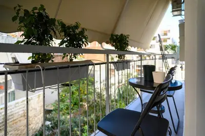a balcony with a table and chairs and plants at Cosy Pangrati Urban Retreat in Athens
