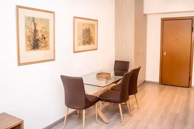 a dining room with a table and chairs at Beachside Bliss Central 1-Bedroom in Glyfada in Athens
