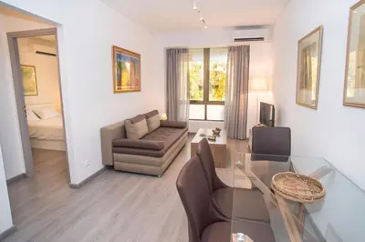 a living room with a glass table and a couch at Beachside Bliss Central 1-Bedroom in Glyfada in Athens