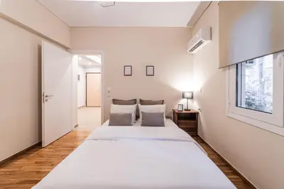 a bedroom with two beds and a window at Athenian Heaven II in Athens