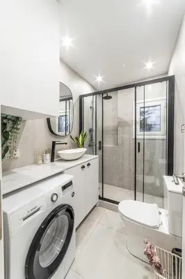 a bathroom with a washing machine and a toilet at Athenian Heaven II in Athens
