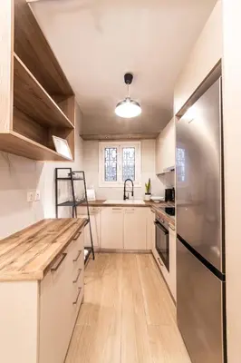 a kitchen with white cabinets and a stainless steel refrigerator at Athenian Heaven II in Athens