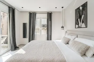 a white bedroom with a large bed and windows at Luna Luxury Suite - close to Acropolis in Athens