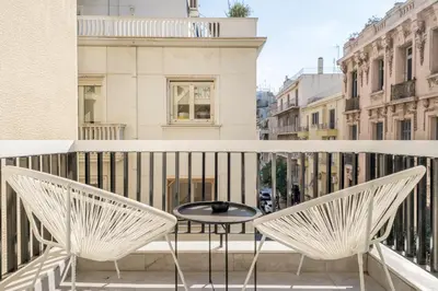 a balcony with two chairs and a table at Luna Luxury Suite - close to Acropolis in Athens