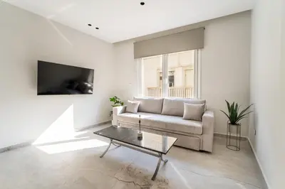 a living room with a couch and a table at Luna Luxury Suite - close to Acropolis in Athens