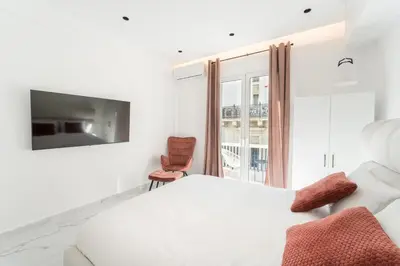 a bedroom with a white bed and a window at Honey Luxury Suite - close to Acropolis in Athens