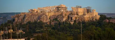 a castle on top of a mountain with trees at Acropolis Luxury Apartment in Athens