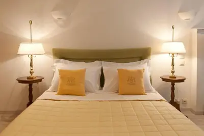 a bedroom with a large bed with two lamps at Acropolis Luxury Apartment in Athens