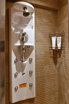 a white sink in a bathroom with a wall at Acropolis Luxury Apartment in Athens