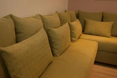 a couch with pillows on it in a living room at Acropolis Luxury Apartment in Athens