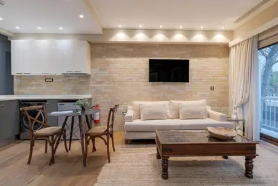 a living room with a couch and a table at Artemis - Luxenia Suites in Athens