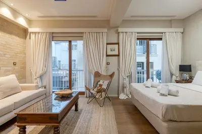 a living room with a bed and a couch at Artemis - Luxenia Suites in Athens