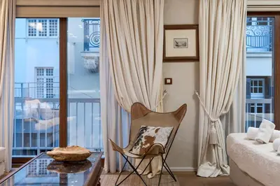 a living room with a bed and a glass table at Artemis - Luxenia Suites in Athens