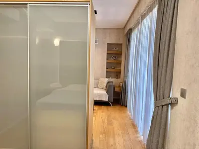 a glass door leading to a bedroom with a bed at Demetra-Luxenia Suites Athens in Athens