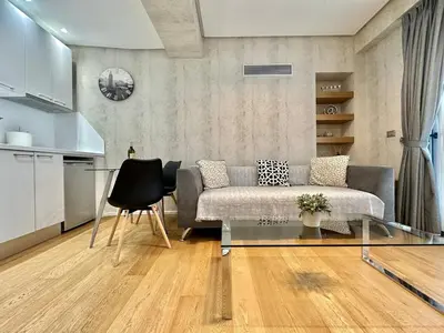 a living room with a couch and a glass table at Demetra-Luxenia Suites Athens in Athens