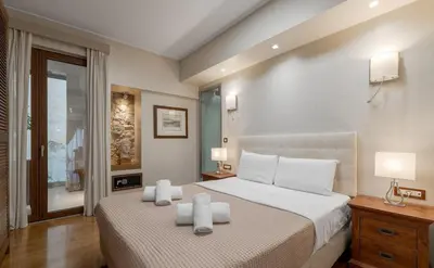 a bedroom with a bed with two white towels on it at Zeus - Luxenia Suites in Athens