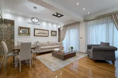 a living room with a couch and a table at Zeus - Luxenia Suites in Athens