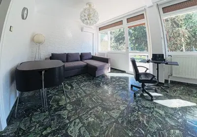 a living room with a couch and a table at Ionos Dragoumi 34 Athens Comfy Studio in Athens