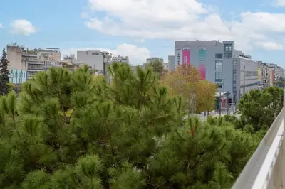 a group of trees in a city with buildings at Apollo - Luxenia Suites in Athens