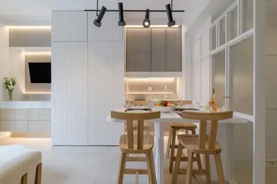 a kitchen with two stools and a table in a room at Apollo - Luxenia Suites in Athens