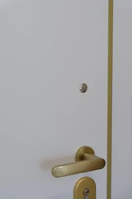 a door with a brass handle and a mirror at Apollo - Luxenia Suites in Athens