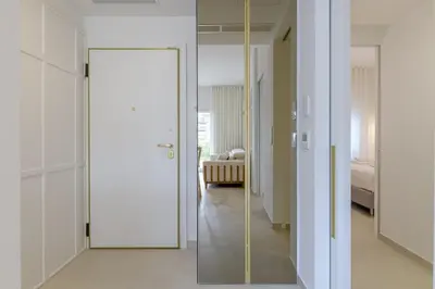 a glass door in a room with a bedroom at Apollo - Luxenia Suites in Athens