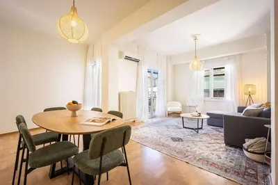 a living room with a table and chairs at Spacious 2BR in Koukaki l Balcony l Near Acropolis in Athens