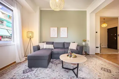 a living room with a blue couch and a table at Spacious 2BR in Koukaki l Balcony l Near Acropolis in Athens