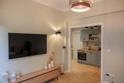a living room with a large flat screen tv on the wall at Vintage-Inspired 2BDR Apt - 15' to Monastiraki in Athens