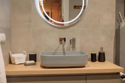 a bathroom with a sink and a mirror at Vintage-Inspired 2BDR Apt - 15' to Monastiraki in Athens