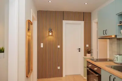 a kitchen with a door with a striped wall at Vintage-Inspired 2BDR Apt - 15' to Monastiraki in Athens