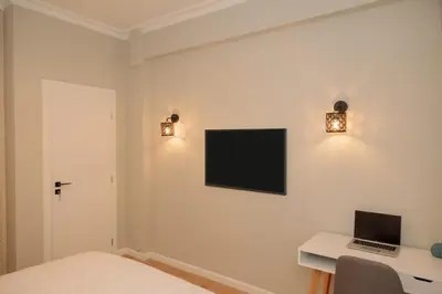 a bedroom with a desk and a laptop on a wall at Vintage-Inspired 2BDR Apt - 15' to Monastiraki in Athens