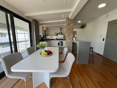 a kitchen and dining room with a white table and chairs at Acropolis Cityscape Loft in Athens