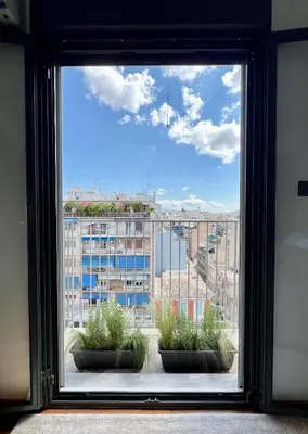 a window with a view of a city at Acropolis Cityscape Loft in Athens