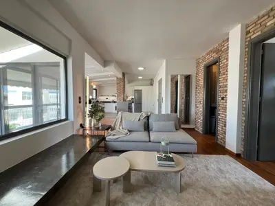 a living room with a couch and a table at Acropolis Cityscape Loft in Athens