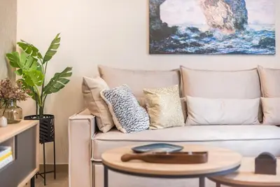 a living room with a couch and a table at Marina Zeas Comfy Apartment in Piraeus