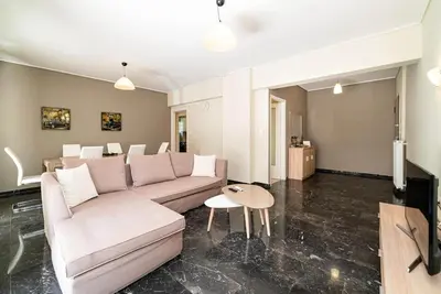 a living room with a couch and a table at The Faliro Oasis in Athens