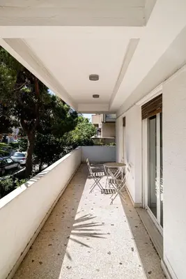a balcony with two chairs and a table on it at The Faliro Oasis in Athens