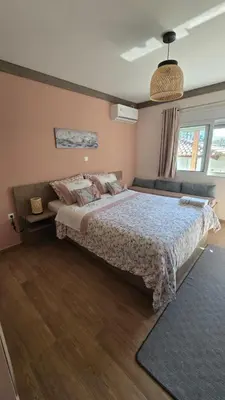 a bedroom with a large bed in a room at Maria guesthouse in Spáta