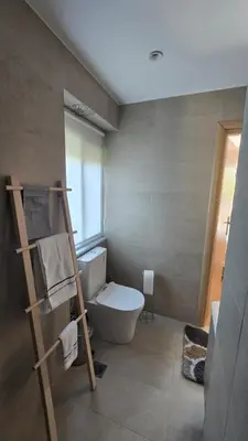 a bathroom with a toilet and a ladder in it at Maria guesthouse in Spáta
