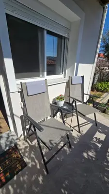 two chairs and a table on a patio at Maria guesthouse in Spáta